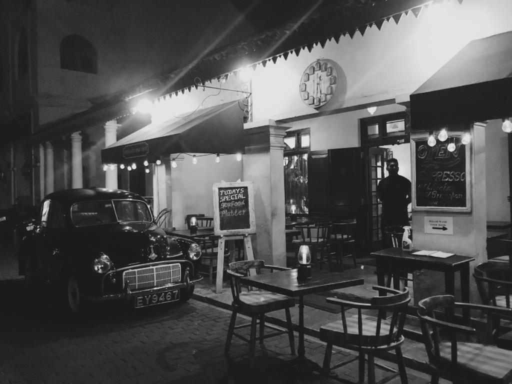 coffee house with a car in front